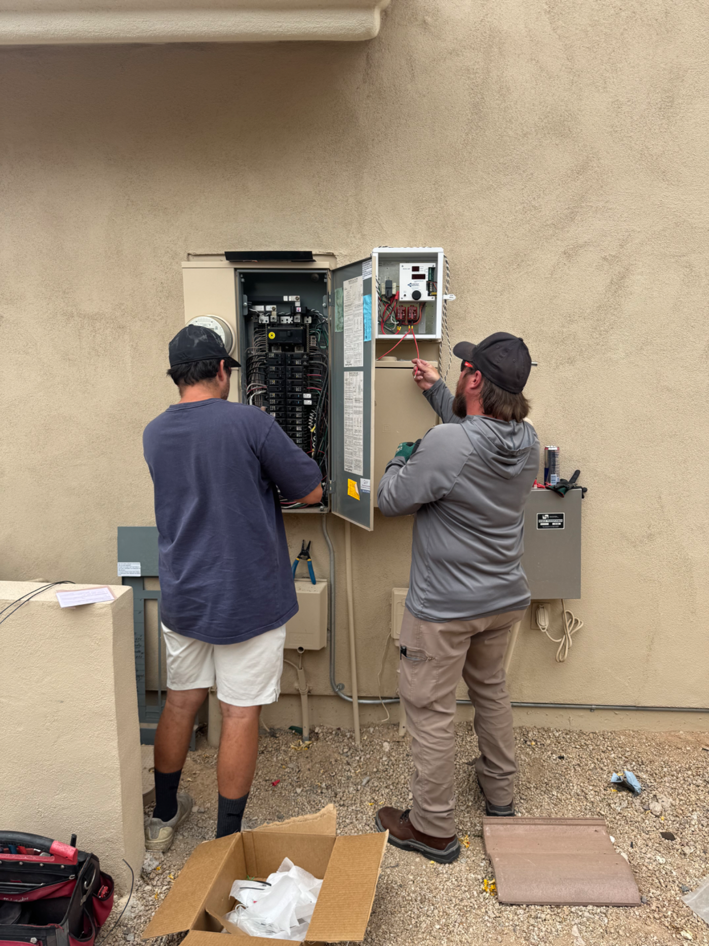Energy Sentry device being installed beside the main electrical panel